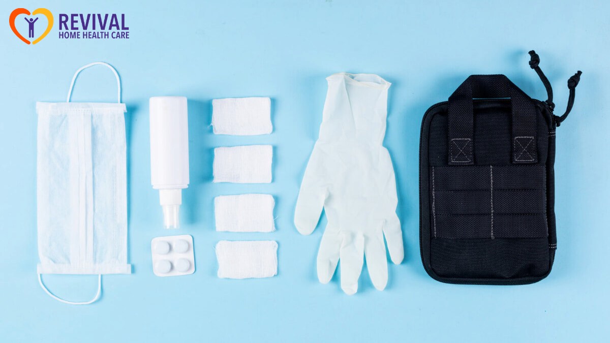 Some medical gloves with hand bag, mask, bandages, spray lined up on light